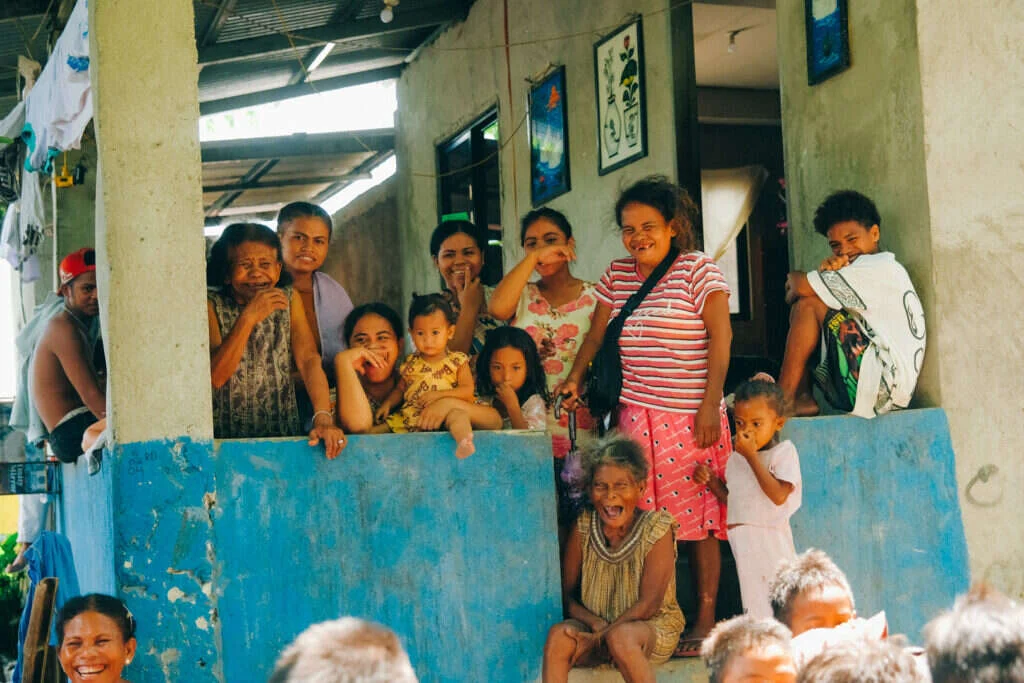 A family gathered at the window and doorway of their home