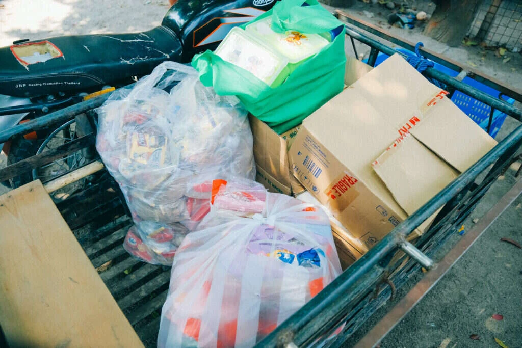 Boxes and bags of relief goods packed onto a motorcycle sidecar